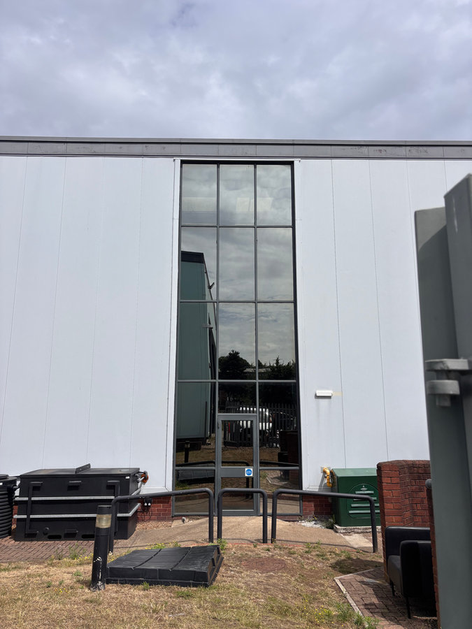 Tall commercial entrance glazing with window film from LuxTint’s portfolio