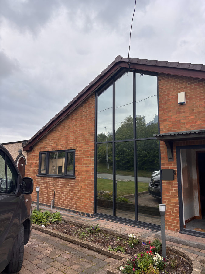 Reflective privacy film on a tall glazed entrance at a home, from LuxTint’s existing work