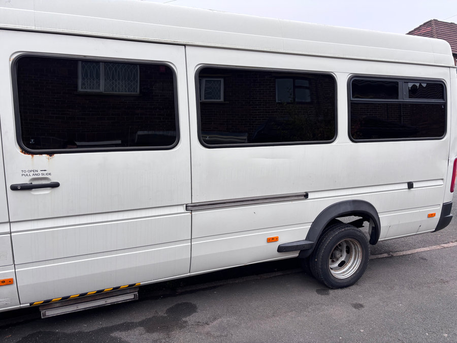 White minibus with dark passenger-window tint from LuxTint’s portfolio